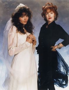 two women standing next to each other in wedding dresses