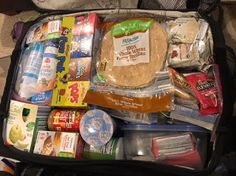 an open suitcase filled with food and snacks