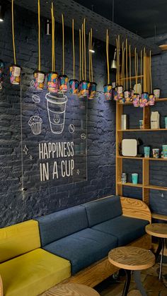 the interior of a coffee shop with blue and yellow furniture