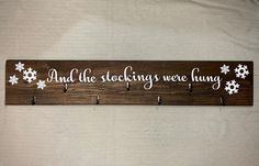 a wooden sign that says and the stocking were hung on it with snowflakes