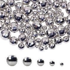 many shiny silver balls are arranged on a white surface