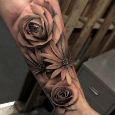 a woman's arm with flowers on it