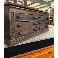 an old dresser with knobs and drawers on display