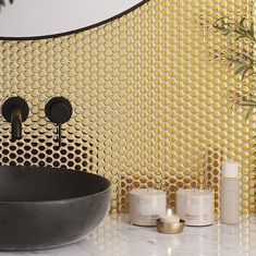 a bathroom with yellow and black wallpaper next to a round sink in front of a mirror