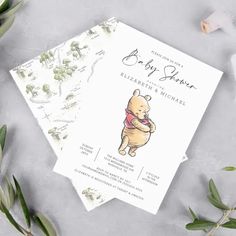 the winnie the pooh baby shower is shown next to greenery and flowers on a gray background