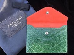 A stunning butter-soft snakeskin pouch from desirable Italian brand Zagliani, a luxury leather goods company founded in Milan in 1947. The dark green python leather is offset with a superb coral-coloured lining, and comes with its own black dustbag with leather label and grosgrain drawstring. The pouch is in brand new condition, and the dustbag has not even had the ribbon inserted and drawn up, so it has not creased or crinkled. It would be great for credit or ID cards, photos, banknotes, jewell Luxury Rectangular Pouch With Interior Card Slots, Designer Leather Pouch For Gifts, Luxury Green Rectangular Pouch, Luxury Gift Pouch, Designer Envelope Pouch For Everyday Use, Luxury Pouch Clutch With Interior Card Slots, Luxury Green Clutch For Daily Use, Luxury Green Pouch For Everyday Use, Luxury Envelope Pouch