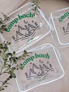 three glass trays with camp back designs on them and some plants in the background