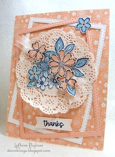 a close up of a card with doily and paper flowers on it, which says thank