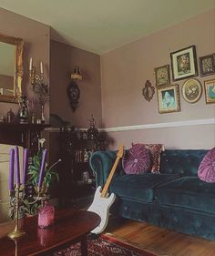 a living room filled with furniture and pictures on the wall