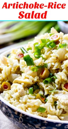 a bowl filled with rice and vegetables on top of a table