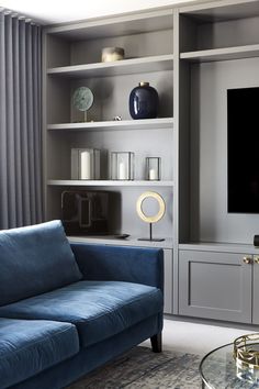 a blue couch sitting in front of a flat screen tv