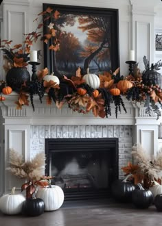 a fireplace decorated for fall with pumpkins and other decorations on top of the mantle