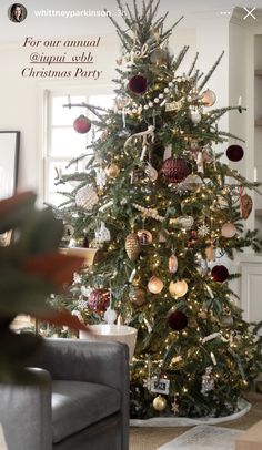 a christmas tree with ornaments on it in a living room