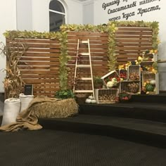 there is a stage set up with hay and pumpkins on the steps next to it