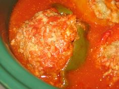 meatballs and peppers are in a green pot