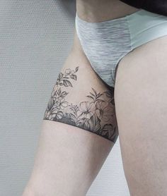 a woman's thigh with flowers on it