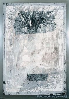 an abstract painting with white and black paint on the bottom half of it, surrounded by branches