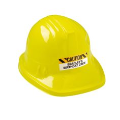 a yellow hard hat with caution stickers on it