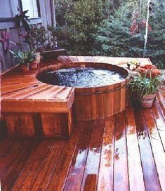 a hot tub sitting on top of a wooden deck