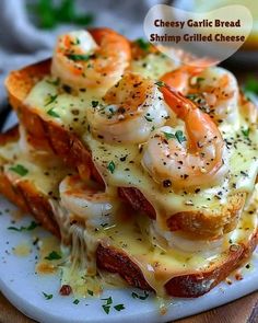 cheesy garlic bread with shrimp grilled cheese on it and garnished with parsley