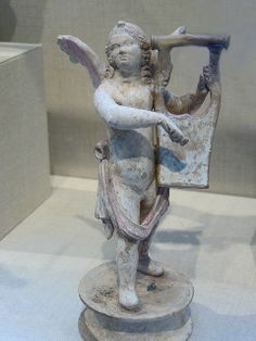 an ancient statue is on display in a museum