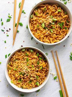 two bowls of noodles with chopsticks on the side