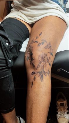 a person with a flower tattoo on their leg