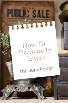 a sign that says how to decorate in layers the junk parlor on top of a desk