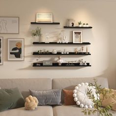 a living room filled with lots of furniture and pictures on the wall above it's shelves