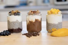 three jars filled with food sitting on top of a table