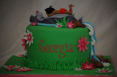 there is a green cake with flowers and people on it that says gorgonia