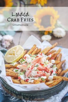 loaded crab fries with lemon wedges on the side