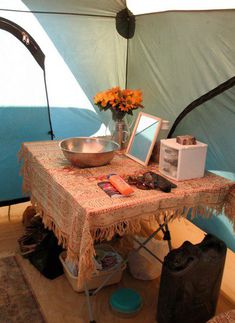 the inside of a tent with a table and chairs