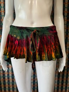 Tie dye micro mini skirt with built in shorts!! Has a very girly fit with the wavy flared hem at the bottom. Shorter in the front and longer in the back.  It's perfect for dancing and spinning in Multicolored tie dyes  Elastic drawstring waist band for easy and snug fit  Matching built in shorts  Soft and comfy material  Perfect for summer time fairycore / wimsical goth aesthetic and can be a great addition for outdoor summer festivals or raves or just perfect for summer!  Stretchy fit One size  XS-L Waist: 28-46in Length: 7.5in Length Back: 11.5in Visit our page for more colors! Please note: each skirt is unique this is a sample photo  Message us with any questions! Cheap Multicolor Skirt For Festival, Multicolor Flowy Beach Mini Skirt, Multicolor Flowy Mini Skirt, Hippie Tie-dye Skirt For Beach, Hippie Tie-dye Skirt For Festival, Multicolor Mini-length Cotton Skort, Festival Mode, Girly Fits, Micro Skirt