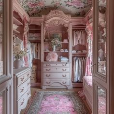 the closet is decorated in pink and white with floral wallpaper on the ceiling, along with an area rug