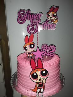 there is a pink cake decorated with cartoon characters