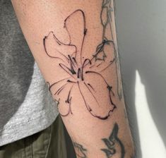 a man with a tattoo on his arm has a flower in the middle of his arm