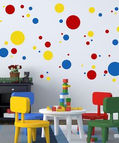 a child's room with colorful polka dot decals on the wall and play table