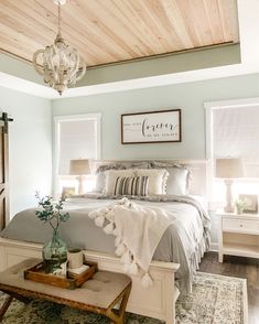 a bedroom with a large bed and wooden ceiling