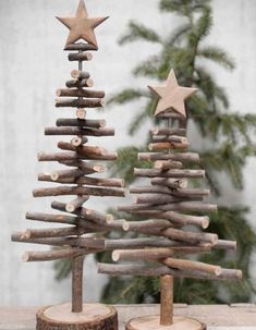 a small wooden christmas tree sitting on top of a table next to a fake star