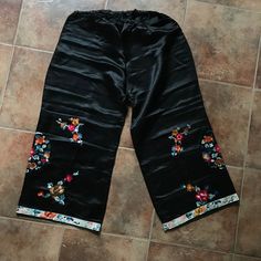 "Vintage black satin pajama pants with embroidered orange, pink, gold, green cherry blossom branches and peonies. LARGE-- SHORT, CROPPED LENGTH CONDITION: excellent- appear unworn VINTAGE: circa 1920 WAIST: elastic 29\" to 40\"\" HIPS: 48\"  LENGTH: 32\", outer seam, 22\" inseam LINING: none LABEL: none MATERIAL: non-stretch satin POCKETS: no NOTES: Wearable, but CAREFULLY.  This item is sent via the US postal service with insurance.  International shipping is $27.  NecromanceNOLA is not responsible for any import fees or delays due to customs." Embroidered Bottoms For Spring Loungewear, Spring Embroidered Bottoms For Loungewear, Vintage Loungewear Pants For Spring, Vintage Spring Loungewear Pants, Spring Vintage Loungewear Pants, Embroidered Summer Sleepwear For Loungewear, Casual Lounge Pants With Floral Embroidery, Traditional Black Bottoms For Spring, Black Pants For Summer Pajama Party