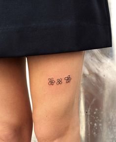 a woman's legs with four clovers tattoo on her left side calfocks