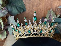 "Beautiful, sparkles, good quality CROWN with big Emerald Green stones, with Crystal Rhinestone set on gold Crown. Perfect for Prom, Birthday, Sweet 16, Quinceanera, Anniversary, Wedding, or for any other special occasion. Or just to be THE QUEEN. THE COLORS ON THE CROWN: Gold the tiara frame, Emerald Green and Crystal-clear Rhinestone THE SIZE 3\" high on the front 1.5 high on the back 5\" diameter. GIFT BOX IT'S NOT INCLUDED! This item it will send on STANDARD FIRST CLASS MAIL (2 to 5 business Emerald Quinceanera, Emerald Green Crown, Crown Emerald, Crown Quinceanera, Crown Frame, Crown Frames, Birthday Sweet 16, Quinceanera Tiaras, Quinceanera Crown