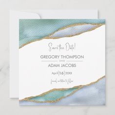 save the date card with gold foil and blue watercolor paint on it's paper