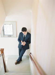 a man in a suit is standing on the stairs