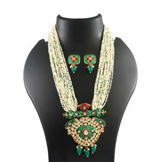 This is a stunning handmade necklace perfect for high end Jewelry Collector, a keeper in Traditional Vintage Indian/Pakistani Bridal jewelry and a Luxury Gift for your Daughter, Sister or Wife on Wedding or Anniversary. Perfect for any type of occasions, weddings And celebrations and a beautiful & memorable gift for weddings and special occasions. -Item Code:- L7063 -White Beaded Necklace Set with Earrings. -Designer multi layered beaded necklace. -Gold Plated Set with Kundan Stones which shine like Polki Diamonds. -Metal: Gold plated brass -Earrings are 36mm long & 21mm wide approx -Push Back Earrings -Necklace length with pendant 11" approx excluding adjustable dori/cord -Quantity:- One Necklace Set Please see more different designs here:- https://www.etsy.com/in-en/shop/LUCKYJEWELSART?r Luxury White Necklace With Meenakari, Traditional Green Pearl Necklace As Gift, Traditional Green Pearl Necklace For Gift, Green Kundan Necklace With Polished Beads As Gift, Green Pearl Necklace For Festivals, Green Meenakari Pearl Necklace Gift, Polki Diamond Necklace, Layered Beaded Necklace, Multi Layer Necklace Beads