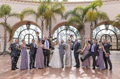 a group of people standing next to each other on top of a tiled floor covered in confetti