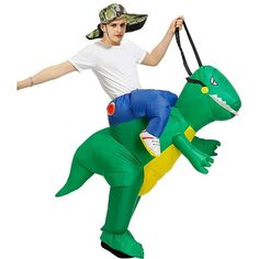 a man riding on the back of an inflatable t - rexe costume