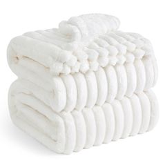 a stack of white towels stacked on top of each other in front of a white background