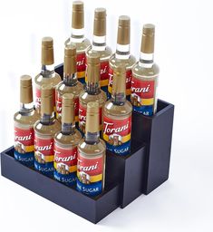 eight bottles of syrup are arranged in a holder